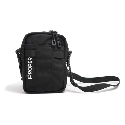 A black mini sling bag with multiple compartments, a key hook, and a durable shoulder strap. The brand 'PROPER' is visible on the front.
