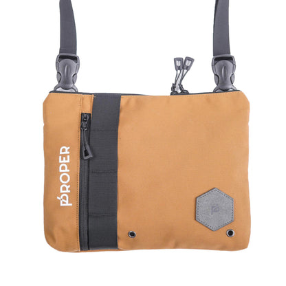 A wooden brown color proper compact sling bag with multiple compartments and a zippered back pocket, featuring a white brand logo on the front.